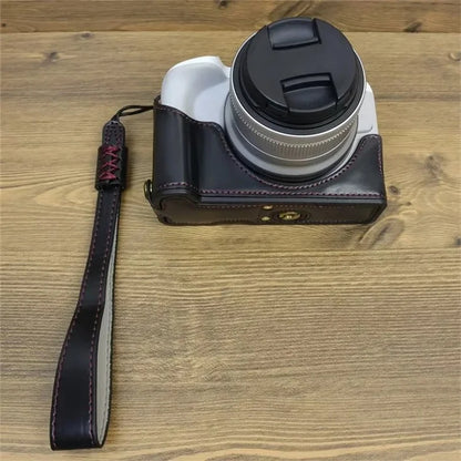 For Canon EOS R50 / R100 PU Leather Bottom Case Half Body Camera Cover with Wrist Strap
