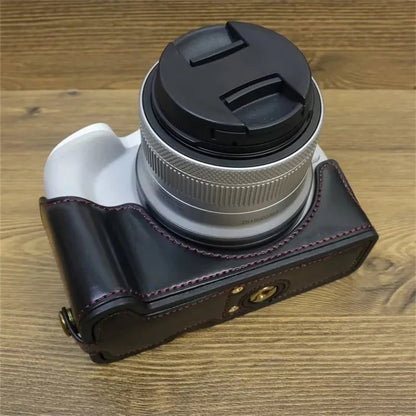 For Canon EOS R50 / R100 PU Leather Bottom Case Half Body Camera Cover with Wrist Strap