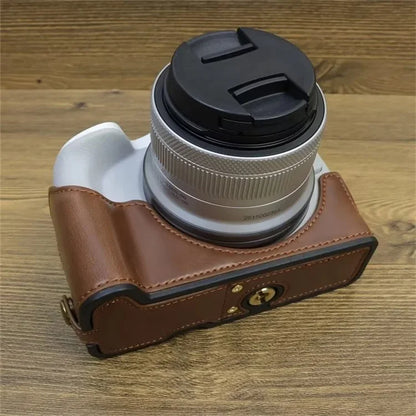 For Canon EOS R50 / R100 PU Leather Bottom Case Half Body Camera Cover with Wrist Strap
