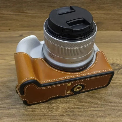 For Canon EOS R50 / R100 PU Leather Bottom Case Half Body Camera Cover with Wrist Strap