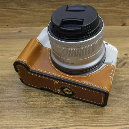 For Canon EOS R50 / R100 PU Leather Bottom Case Half Body Camera Cover with Wrist Strap