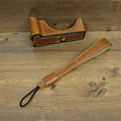 For Canon EOS R50 / R100 PU Leather Bottom Case Half Body Camera Cover with Wrist Strap