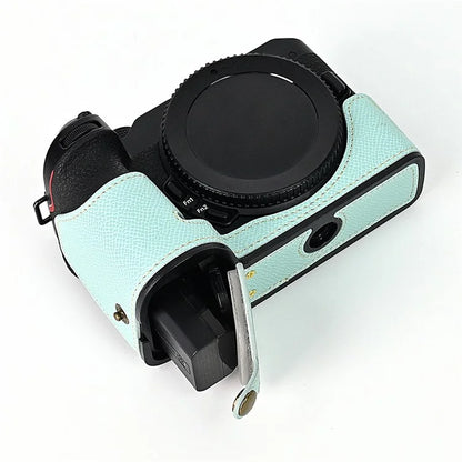 For Nikon Z30 / Z50 Battery Opening Design PU Leather Camera Cover Palm Texture Half Body Bottom Case with Wrist Strap