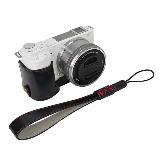 For Sony ZV-E10 Battery Opening Design PU Leather Camera Cover Half Body Bottom Case with Wrist Strap